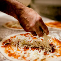 How is pizza made and what are the main ingredients?